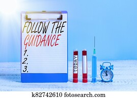 Text sign showing Follow The Guidance. Conceptual photo controlling a course of projectile by builtin mechanism Extracted blood sample vial with medical accessories ready for examination.