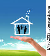 human hands holding model of a house   nature background 