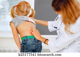 Pediatrician examining little girl with back problems. Pediatrician examining little girl with back problems.