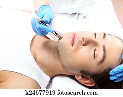Portrait of a young man groomed during the treatment in the beauty salon Portret zadbanego mlodego mezczyzny podczas zabiegu w salonie kosmetycznym Portrait of a young man groomed during the treatment in the beauty salon Portret zadbanego mlodego mezczyzny podczas zabiegu w salonie kosmetycznym