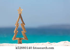 Timber Christmas tree in sand on the beach Timber Christmas tree in sand on the beach