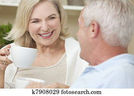 Happy Senior Man & Woman Couple Drinking Tea or Coffee