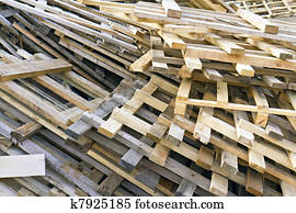 piled into a heap of wooden pallets