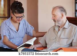 carer reading to senior