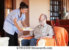 elderly senior being brought meal by carer or nurse
