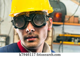 Closeup of an industrial worker in yellow helmet