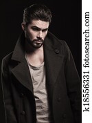 portrait of a serious fashion man with beard 