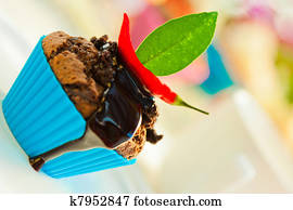 Hot chocolate cupcake with liquid chocolate and a red chili as a outdoor shooting Hot chocolate cupcake with liquid chocolate and a red chili as a outdoor shooting