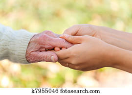 Senior and young holding hands Senior and young holding hands