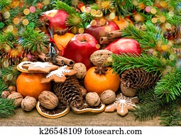 Fruits, cookies and spices. Christmas background with lights