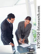 Businesswoman showing partner where to sign