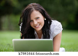 Female Lying on Grass Using Laptop