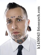 Adult male with tattoos and piercings.