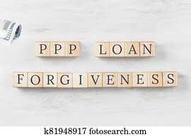 PPP LOAN Forgiveness text on wooden background with dollars roll PPP LOAN Forgiveness text on wooden background with dollars roll