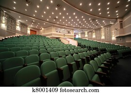 Side view on an arrangement of green seats and registration of walls in conference room