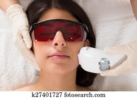 Beautician Giving Epilation Laser Treatment Beautician Giving Epilation Laser Treatment