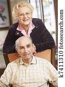 Senior couple relaxing in armchairs