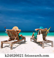 Couple in green relax on a beach at Maldives