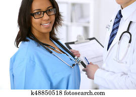 Female african american medical doctor with colleague in hospital