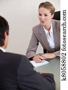 Portrait of a serious manager interviewing a male applicant