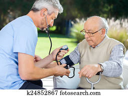 Doctor Measuring Blood Pressure Of Senior Man