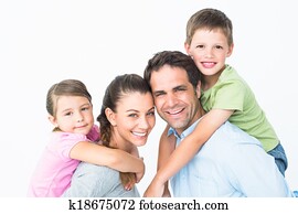 Cheerful young family looking at camera together