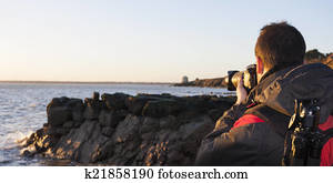 Young adult photographing