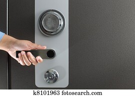 Hand opening a safe Hand opening a safe