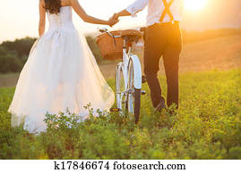 Bride and groom with a white wedding bike Bride and groom with a white wedding bike