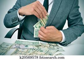 man in suit getting dollar bills in his jacket