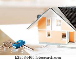 Miniature Home and Key on Top of Blueprint