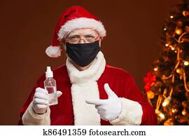 Santa Claus in mask and with antiseptic Santa Claus in mask and with antiseptic