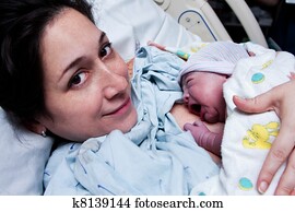 Happy mother holding newborn baby after birth Happy mother holding newborn baby after birth