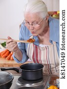 A grandmother cooking. A grandmother cooking.