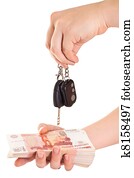 Car key in hand and cash money in other hand isolated ob white background