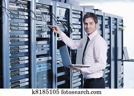 young it engineer in data center server room young it engineer in data center server room