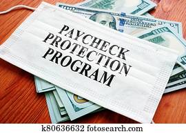 PPP Paycheck Protection Program as SBA loan written on the mask and money. PPP Paycheck Protection Program as SBA loan written on the mask and money.