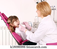 dentist and little girl patient dental exam
