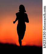 Woman jogging at sunset 