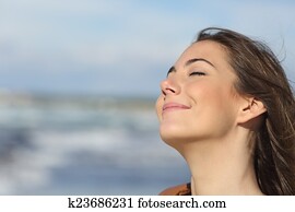 Closeup of a woman breathing fresh air on the beach