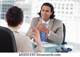 Happy manager interviewing a female applicant