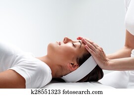 Woman relaxing at reiki session. Woman relaxing at reiki session.