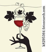 A hand holding a wine glass with gr A hand holding a wine glass with gr