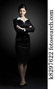 Confident business woman standing full length in black suit