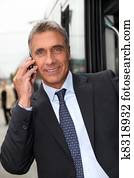 businessman making call outdoors