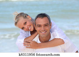Couple dressed in white at the beach