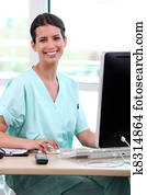 Medical assistant working behind her computer