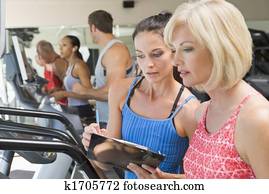 Personal Trainer Instructing Woman On Treadmill Personal Trainer Instructing Woman On Treadmill
