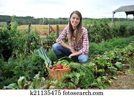 Woman knelt in vegetable garden Woman knelt in vegetable garden