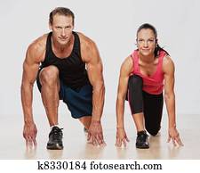 Athletic man and woman doing fitness exercise Athletic man and woman doing fitness exercise